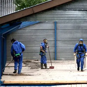 Men collecting building materials for asbestos test